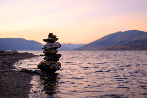 A cairn during sunrise at lake Wanaka