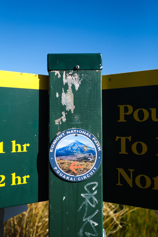 Signpost with a plaque for the Pouakai Circuit