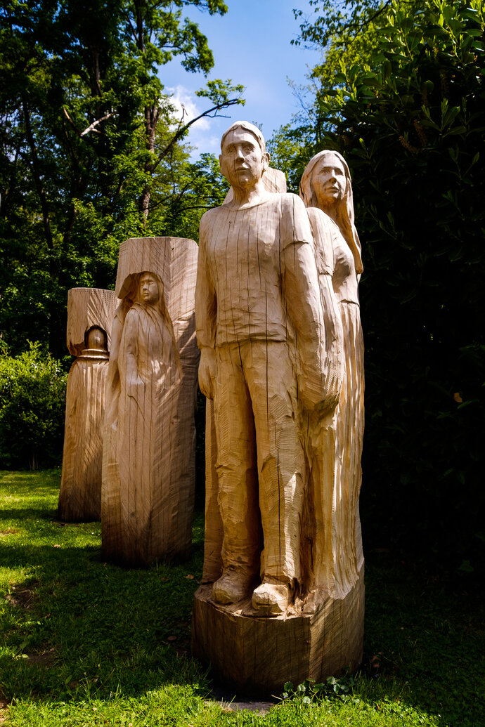 Sculptures of people carved from a tree trunk