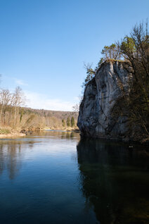 Huge rock with iron letters on the river bank