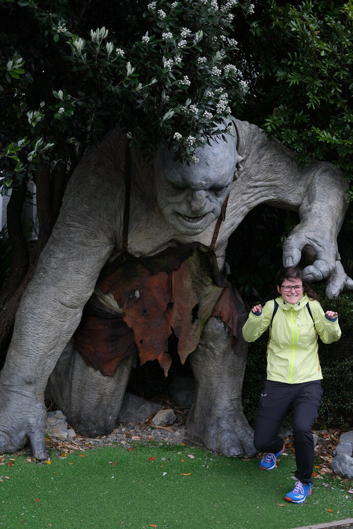 Woman posing in front of troll
